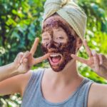 Woman exfoliating her skin with Health Embassy natural body scrubs for soft and radiant skin