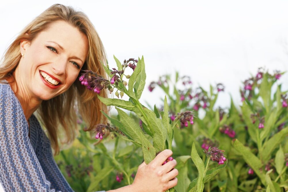Herbal Remedies for Menopause.Smiling middle-aged woman in field.