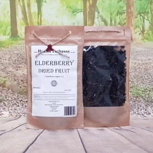 Organic Elderberry Dried Fruit by Health Embassy in a natural brown paper bag on a wooden surface, showing deep purple-black berries with a rustic backdrop.