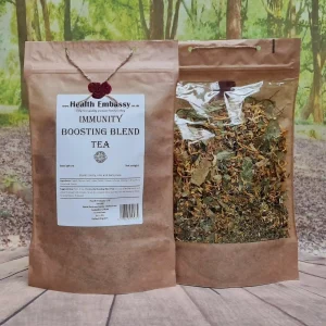 Paper bag of Immunity Boosting Blend Tea by Health Embassy on wooden surface with green background