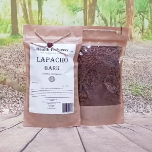Health Embassy Lapacho Bark (Tabebuia impetiginosa) dried herbal tea in brown paper bag on wooden table with green background