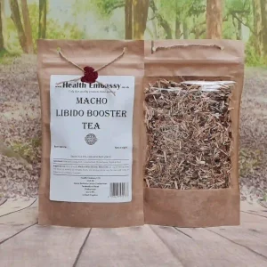 Macho Libido Booster Tea by Health Embassy in a resealable brown bag on a wooden surface with loose herbal blend visible