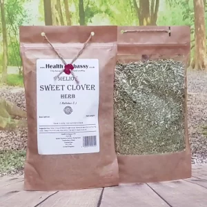Brown paper pouch of pure Meliot Sweet Clover Herb by Health Embassy on a wooden table with green background, hand-packed and pesticide-free.