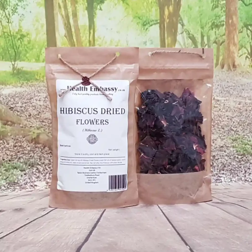 Health Embassy dried Hibiscus flower petals in paper pouch on rustic wooden table