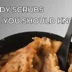 Bowl of natural body scrubs with wooden spoon, showing textured exfoliating ingredients