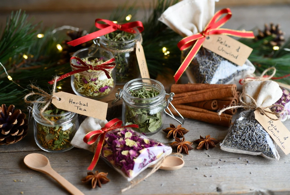 Festive DIY Herbal Gift Kits by Health Embassy with jars of dried herbs, flowers, and spices for Christmas presents